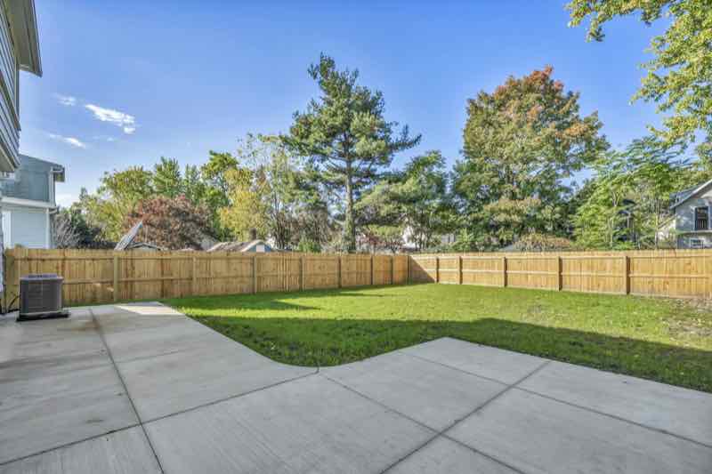 New cedar fence behind a concrete patio